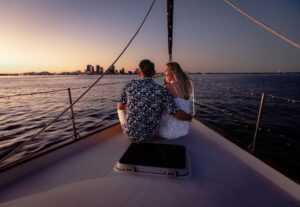 Couple relaxing on the bow during a private sunset sail in St. Petersburg