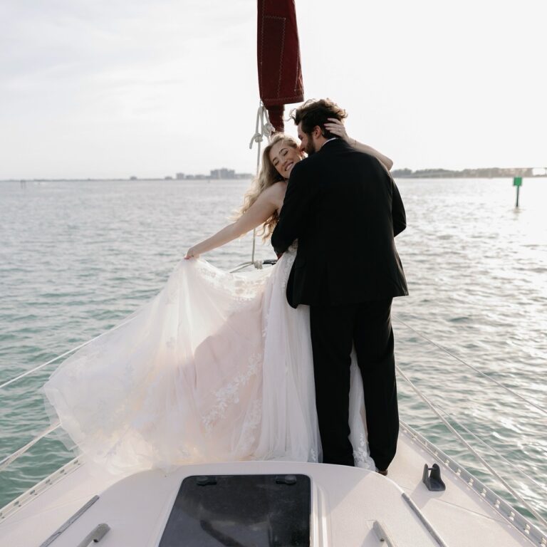 Bride and groom on the bow during a sailboat wedding in St. Petersburg